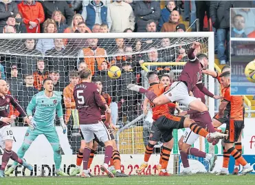  ?? ?? Hearts’ Craig Halkett soars above everyone to head home a late leveller