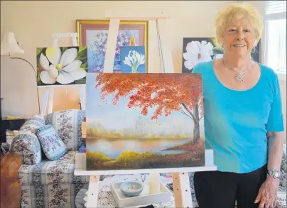  ?? JEREMY FRASER/CAPE BRETON POST ?? Cassie MacLeod stands by her artwork in the basement studio of her North Sydney home. MacLeod will be this year’s featured artist at the Autumn Treasures Art Show, hosted by Rt. Hon. Vincent Massy Chapter IODE.