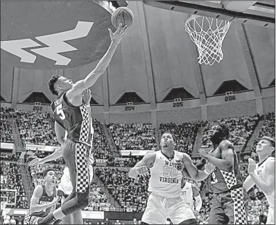  ?? AP/The Dominion-Post/WILLIAM WOTRING ?? Kentucky forward Kevin Knox attempts a layup over West Virginia forward Sagaba Konate during the second half Saturday in Morgantown, W.Va. Knox scored 34 points to lead Kentucky to an 83-76 victory.