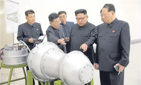  ??  ?? Kim Jong Un inspects what is claimed to be a nuclear device in a photo released by state media yesterday.