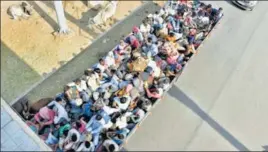  ?? AJAY AGGARWAL /HT/PTI ?? Migrants aboard a truck stranded at the Ghazipur border after they were stopped from entering UP on foot; workers wait to board a train outside Lokmanya Tilak Terminus in Mumbai; and migrants ride a truck on Agra-Delhi National Highway in Mathura on Saturday.