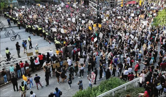  ?? CURTIS COMPTON / CCOMPTON@AJC.COM ?? More than 1,000 protesters fill Marietta Street at Centennial Olympic Park Drive outside the CNN Center during a fifth day of protests.