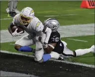  ?? ISAAC BREKKEN — THE ASSOCIATED PRESS ?? Los Angeles Chargers wide receiver Tyron Johnson scores a touchdown against the Las Vegas Raiders’ Daryl Worley during the first half Thursday in Las Vegas.
