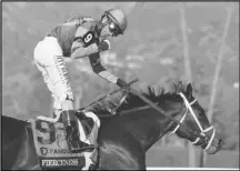  ?? Associated Press ?? John Velazquez celebrates after riding Fierceness to victory in the Breeders’ Cup Juvenile horse race on Friday at Santa Anita Park in Arcadia.