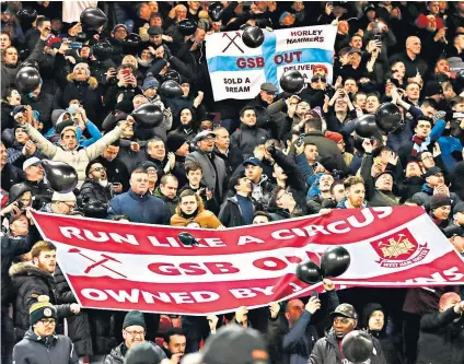  ??  ?? United front: West Ham fans make their feelings known before their recent match at Anfield; Karren Brady (right), club vice-chairman, has come under fire over her pay and bonus