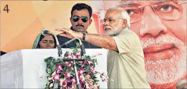  ?? ASHOK DUTTA/HT PHOTO ?? Prime Minister Narendra Modi adjusting the mike for village pradhan Durga Devi at Jayapur village in Varanasi on Friday.