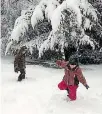  ??  ?? Liam King, 7, and Aria King, 6, play in the snow on the first day of the snow dump.