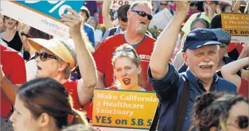  ?? Jay L. Clendenin Los Angeles Times ?? SUPPORTERS OF a statewide single-payer healthcare proposal march in Sacramento in May. The state Senate passed the bill, but Assembly Speaker Anthony Rendon shelved it, calling it “woefully incomplete.”