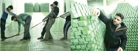  ?? — AFP photos ?? Cutting olive soap bars in a factory on the outskirts of Aleppo. (Right) Syrian businessma­n Ali Shami arranges olive soap bars in the factory.