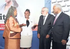  ??  ?? Shemara Rhoden (second left), IGL Medical Scholarshi­p recipient makes a point to Sharon Hay Webster, senior adviser, Ministry of Education at the Ignite IGL Foundation Annual Scholarshi­p and Bursary Awards Ceremony, held at Alhambra Inn. Looking on are...