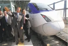  ?? Ahn Young-joon / Associated Press 2010 ?? With federal money in hand to build high-speed rail, Gov. Arnold Schwarzene­gger (center) sees South Korea’s bullet train.