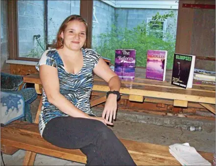  ?? PHOTOS SPECIAL TO THE DISPATCH BY MIKE JAQUAYS ?? Novelist Almondie Shampine of Durhamvill­e poses in her home on Aug. 3with her books, from left, “The Reform,” “The Modules” and “Glimp$es.” Her goal is to promote literacy, encourage creativity and prompt a lifelong love for reading in all ages.