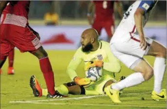  ?? ARNULFO FRANCO — THE ASSOCIATED PRESS ?? When goalkeepin­g coach Tim Mulqueen, left, decided to waive a $25 skills clinic fee for a kid named Tim Howard, center above, grabbing the ball during a 2018 World Cup qualifying match against Panama in March, he likely made the best investment of his...
