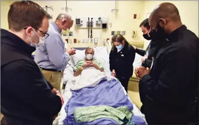  ?? Christian Abraham / Hearst Connecticu­t Media ?? Deacon Tim Bolton, with the Diocese of Bridgeport, second from left, leads in a prayer over patient Jack Cade and his wife Julia, of Norwalk, during pastoral care training with three seminarian­s at St. Vincent’s Medical Center in Bridgeport on Wednesday. Bridgeport native Andrew LaFleur, at left, Ferry Galbert, at right, and Miguel Betancur Lenis all attend St. Joseph Seminary in Yonkers and train in pastoral care at the hospital every week.