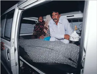  ?? Photo: REUTERS ?? Love punished: Mohammad Iqbal sits next to his wife Farzana’s body. She was stoned to death by family members in Lahore on Tuesday.