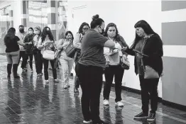  ?? Jessica Phelps / Staff photograph­er ?? Employees of San Antonio Independen­t School District wait in line at the Wonderland of the Americas mall to receive COVID-19 vaccinatio­ns last month. University Health was expecting to vaccinate more than 5,000 SAISD workers over two days.