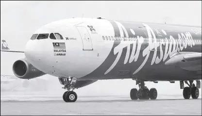  ??  ?? An AirAsia X Airbus A340 passenger jet arrives on its inaugural flight from Kuala Lumpur to Paris Orly Airport.