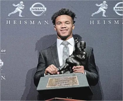  ?? CRAIG RUTTLE THE ASSOCIATED PRESS ?? Oklahoma quarterbac­k Kyler Murray, pictured here with the Heisman Trophy, was also drafted by baseball’s Oakland A’s in June.