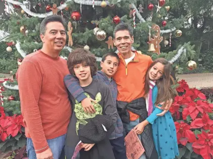  ?? SUBMITTED ?? Craig Yabuki, left, celebrates Christmas at the Mitchell Park Domes in 2016 with his twin sons Owen and Grant, brother Jeff, and daughter Lauren.