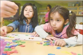  ?? Hearst Connecticu­t Media file photo ?? Preschoole­rs work on a word puzzle during class. Low-income families in Connecticu­t find it difficult to afford high-quality child care. That leads to lower quality education for their children, according to the Middlesex United Way.