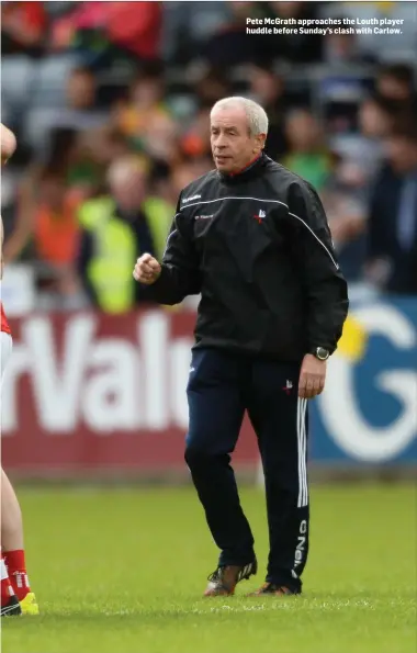  ??  ?? Pete McGrath approaches the Louth player huddle before Sunday’s clash with Carlow.