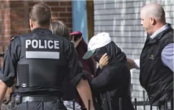  ?? PATRICK SANFACO/LA PRESSE ?? The RCMP and Montreal police escorted three people out of an apartment where they believe Amor Ftouhi lives.