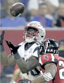  ?? DARRON CUMMINGS/AP ?? New England’s Martellus Bennett catches a pass while under pressure from Atlanta’s Keanu Neal during the second half of Super Bowl 51 on Sunday in Houston.