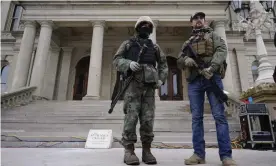  ?? Photograph: Paul Sancya/AP ?? Armed men stand at the Michigan Capitol after a pro-Trump rally on Wednesday.