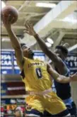  ?? CHRIS SZAGOLA — THE ASSOCIATED PRESS ?? La Salle’s Pookie Powell, left, puts up a shot as Rhode Island’s Cyril Langevine, right, defends on Tuesday.