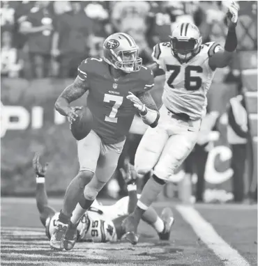  ?? KELLEY L. COX, USA TODAY SPORTS ?? 49ers quarterbac­k Colin Kaepernick, trying to elude Panthers defenders last weekend, has been held under 200 yards passing in seven of nine games this season and has a 56.4% completion rate.