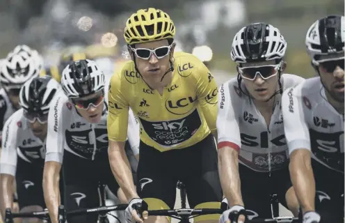  ??  ?? 2 Geraint Thomas, in the overall leader’s yellow jersey, rides with his Sky team-mates on his way to winning this year’s Tour de France.