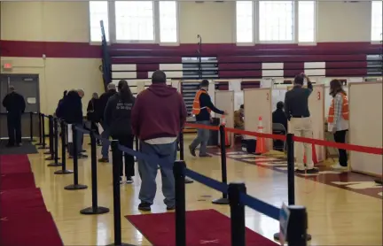  ?? TANIA BARRICKLO — DAILY FREEMAN ?? Ulster County residents wait in line at the newly opened COVID-19vaccinat­ion center in the Kate Walton Field House at Kingston High School on Monday, Jan. 11.