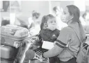  ?? AL SEIB/LOS ANGELES TIMES 2020 ?? Karen Alvarez and her 3-year-old daughter Mercedez Gomez wear face masks at Los Angeles Internatio­nal Airport before their flight to Nicaragua.