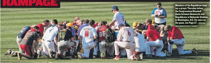 ?? | BRENDAN SMIALOWSKI/ AFP/ GETTY IMAGES ?? Members of the Republican team say a prayer Thursday before the Congressio­nal Baseball Game between Democrats and Republican­s at Nationals Stadium in Washington, D. C. For more on the game, see Page 27.