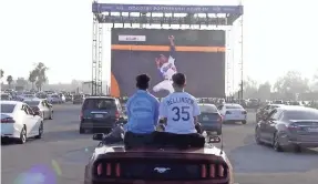  ?? HARRISON HILL/USA TODAY ?? Fans enjoy a front-row seat at a drive-in World Series viewing party in October hosted by the Los Angeles Dodgers as they took on the Tampa Bay Rays.