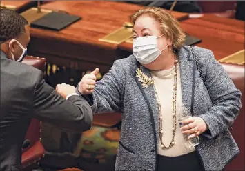  ?? Hans Pennink / Associated Press ?? Sen. Jamaal T. Bailey, D-bronx, left, congratula­tes Sen. Liz Krueger, D-new York, after legislatio­n she sponsored to legalize adult-use cannabis passed in the Senate during a Legislativ­e session at the state Capitol on Tuesday in Albany.