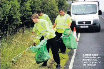  ??  ?? Keep it clean The team tackles litter that has been dropped at the roadside