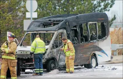  ?? KRISTI GARABRANDT — THE NEWS-HERALD ?? Mentor firefighte­rs begin clean up Feb. 15 at the scene of a Laketran bus fire on Route 306.