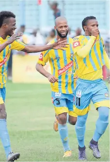  ?? FILE ?? Waterhouse’s players Carlos Wright (left) with Theo Brown (centre) and goalscorer Kemar Beckford celebrate a goal in a recent Red Stripe Premier League match this season.