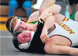  ?? GARY MIDDENDORF/DAILY SOUTHTOWN ?? Ryan Boersma, top, who wrestles for Mount Carmel after transferri­ng from Providence, checks the clock during the 285-pound match against Montini at the Mount Carmel quad meet in Chicago on Dec. 7, 2019.