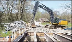  ?? (Courtesy Photo/Victoria Barnes) ?? An excavator is parked in March on the north side of the Dawn Hill East bridge next to a pile of rubble made up of cement and steel and that was once the driving surface of the bridge over Flint Creek.