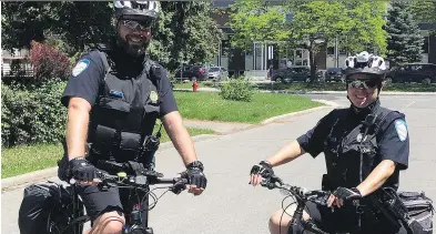  ?? POSTMEDIA NEWS ?? Constables Éric Pimparé and Lisa-Marie Bridges from Station 5 in Pointe-Claire patrol near École secondaire Félix-Leclerc. The veteran officers keep an eye out for good and bad behaviour.