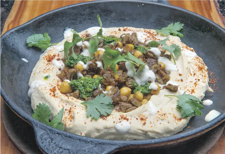  ?? PETER J. THOMPSON / NATIONAL POST ?? Bonnie Stern’s Baked Hummus With Meat and Hawaij Spice should be served with challah or pita.