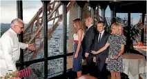  ?? PHOTO: REUTERS ?? French chef Alain Ducasse, left, gestures as, from right, Brigitte Macron, wife of French President Emmanuel Macron, US President Donald Trump and First Lady Melania Trump gather at the Jules Verne restaurant before a private dinner at the Eiffel Tower...