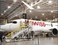  ?? RYAN REMIORZ/THE CANADIAN PRESS ?? Bombardier employees work on CSeries 300 jets at the company’s plant in Mirabel, Que., on Sept. 28. Bombardier Inc. has announced it will partner with Netherland­s-based aerospace giant Airbus on its CSeries program.