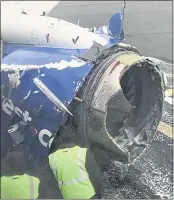  ?? AMANDA BOURMAN VIA AP ?? The engine on a Southwest Airlines plane is inspected on the runway at Philadelph­ia Internatio­nal Airport after the plane made an emergency landing Tuesday.