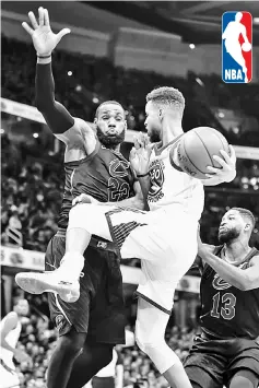  ??  ?? Stephen Curry (centre) of the Golden State Warriors collides with LeBron James (left) of the Cleveland Cavaliers while driving to the basket at Quicken Loans Arena in Cleveland, Ohio in this Jan 15 file photo. — AFP photo