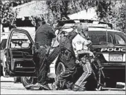  ?? OMAR ORNELAS/DESERT SUN ?? Law enforcemen­t officers converge on a home after shots were fired at police in Palm Springs, Calif., on Saturday.