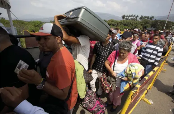  ?? FOTO: TT-AP/FERNANDO VERGARA ?? Venezuelan­er köar vid en gränsöverg­ång till Colombia. Runt 7 procent av landets befolkning bor utanför Venezuela och 1,6 miljoner har flytt de senaste 2,5 åren, enligt siffror från UNHCR.