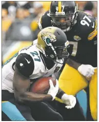  ?? Peter Diana/Post-Gazette ?? The Jaguars running game, led by Leonard Fournette, proved to be too much to handle for Cam Heyward, right, and the Steelers rush defense Sunday. Jacksonvil­le finished with 231 total rushing yards.